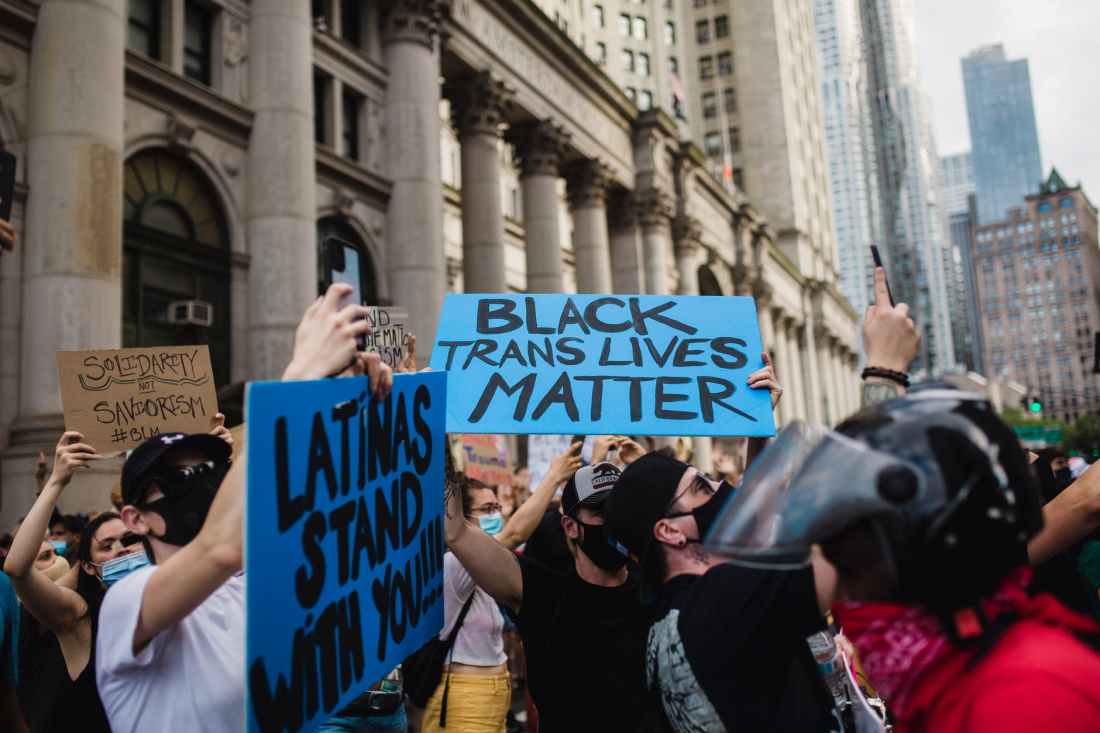 crowd of protesters holding signs